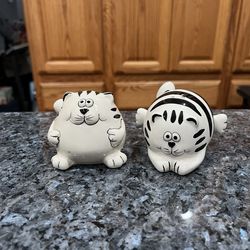 Vintage Pier One Black and White Striped Fat Cat Pair Salt and Pepper Shakers.  Preowned never used.  Has been on display in a cabinet with a very lar