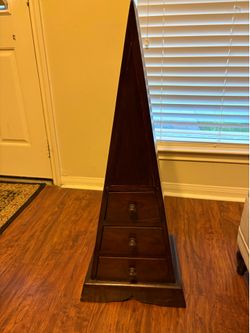 Unique solid wood triangular accent cabinet with three storage drawers. Finished in a dark espresso/brown stain, this piece works well as an accent ta