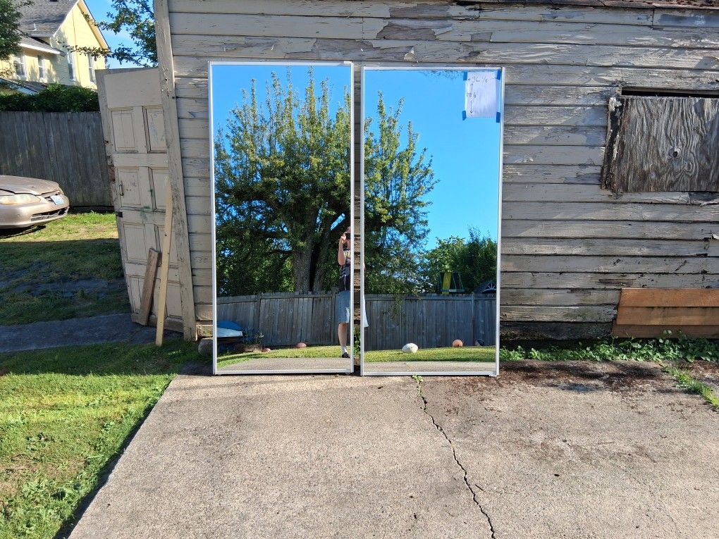 2 Mirrored Closet Doors, each of which measured at a width of