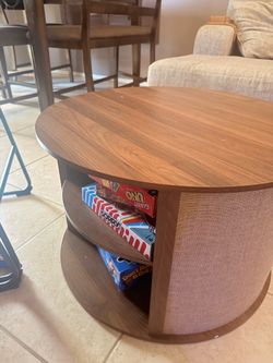 Round wooden coffee table with shelves
