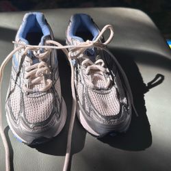 Stylish women's sneakers with white mesh and blue accents. 