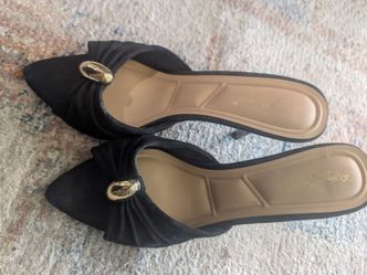 Anne Michelle black pointed-toe slip-on mules.