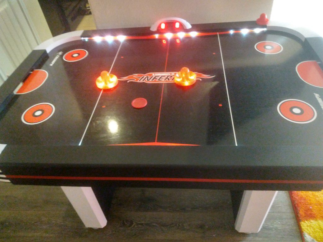Air hockey table- lights up, makes sounds and scoreboard works