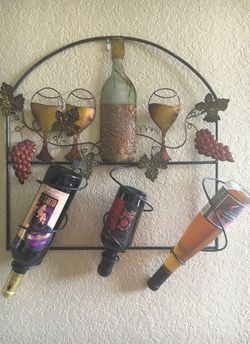 Decorative wine rack. Metal hand design.
