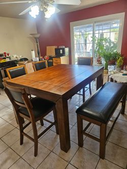 Height dining table with 4 bar stools and bench.