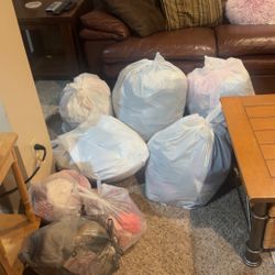 Bags of baby girl stuff and some women’s clothes