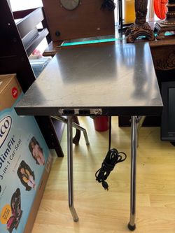 Small collapsible metal table with outlets