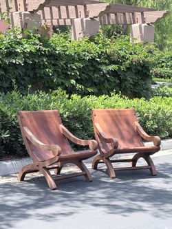 Pair of vintage Mexican handmade Butaque leather armchairs. Solid wood frame, thick leather seats, beautiful aged patina. Spanish Colonial / Hacienda 