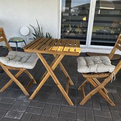 Folding Slatted Wood Table with chairs outdoor indoor dark brown cushions 
