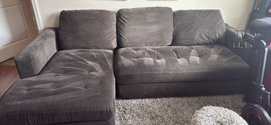 Dark grey sectional with chase