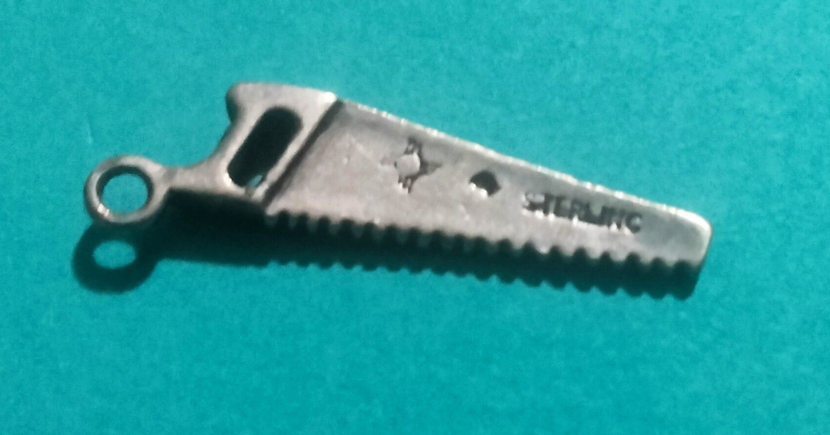 Vintage "Saw Charm" Silver