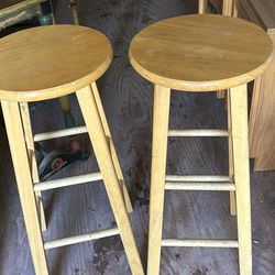 a pair of wood barsstools 30 inches tall