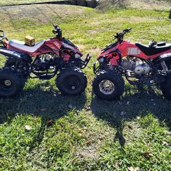 Two 4 Wheelers, Charger, and Battery 