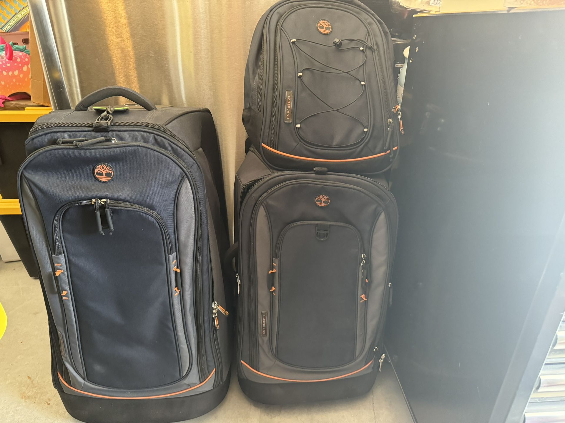 Two Timberland Suitcases And One Backpack
