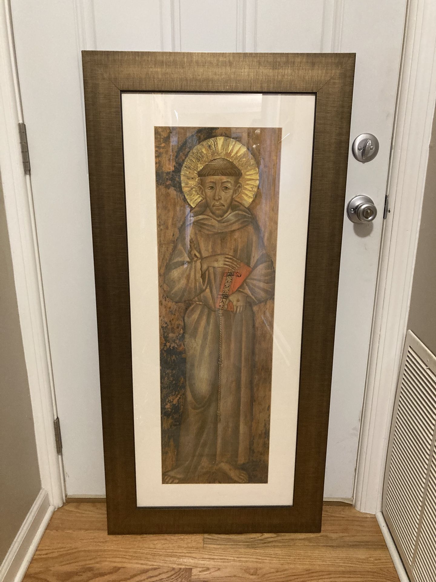 Large framed Saint Francis artwork.