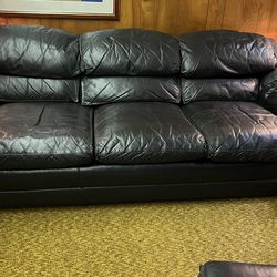 Hancock and Moore - Sofa with matching ottoman in Black leather. both on wheels