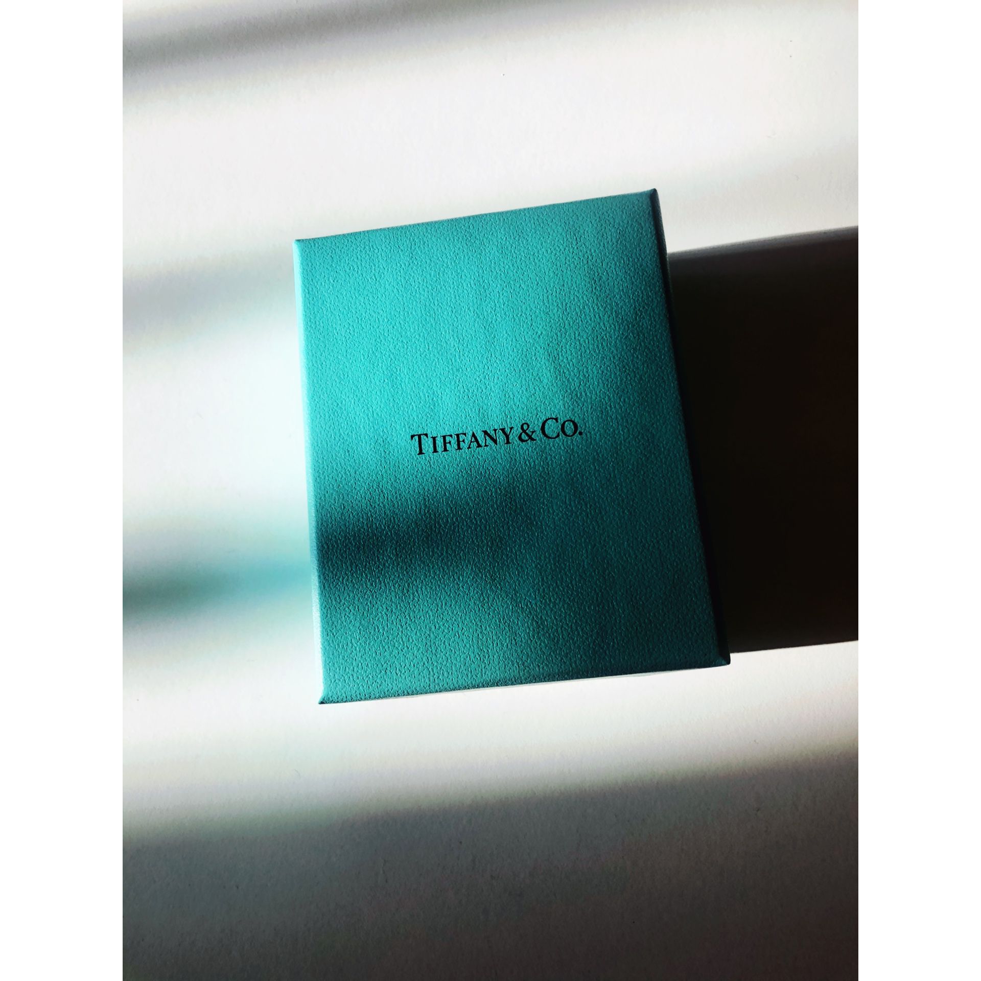 empty Tiffany blue box with ribbon