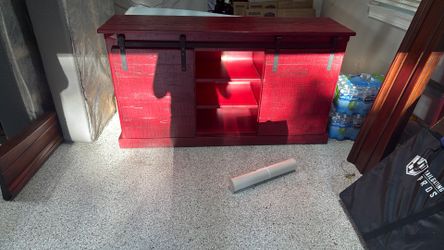 Red TV entertainment center with barn doors
