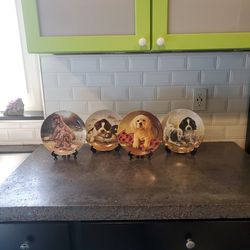collection of 4 Knowles puppy dog plates with stands. 