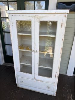 White solid wood cabinet with 4 shelves, drawer & doors with glass