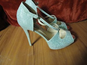 Steve Madden glittery silver high-heeled sandals.
