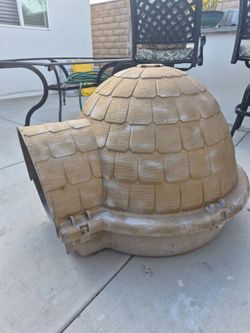 Fiberglass dog house. 33 inches tall, 35 wide and 38 inches deep.