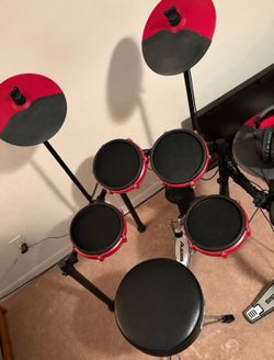 Alesis Nitro Mesh Special Edition (the red-and-black version) complete with headphones and throne .