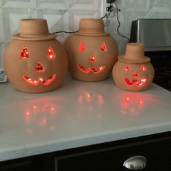 Set of 3 -  TERRA COTTA JACK O’ LANTERNS full of orange lights (small hat has glued crack in back) (10x9.5, 10 x 10.5”, 7x7”) SEE PHOTOS