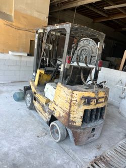 4100 lb TCM forklift LPGAS triple mast side shift Hard tires and runs good.