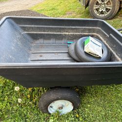 Small black material trailer for a TV riding one more