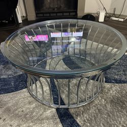 Blue Rug And Clear Glass Coffee Table 
