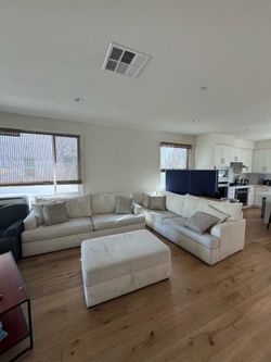 Two Living Spaces couches with storage ottoman