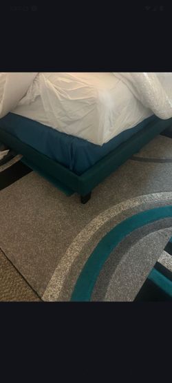 Teal full-size bed with bedframe and mattresses