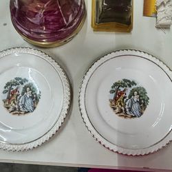 The Harker Pottery Company Victorian Themed 22k gold Rimmed matching 6 1/4” saucer sized plates.  Good vintage condition 2 plates in set. 