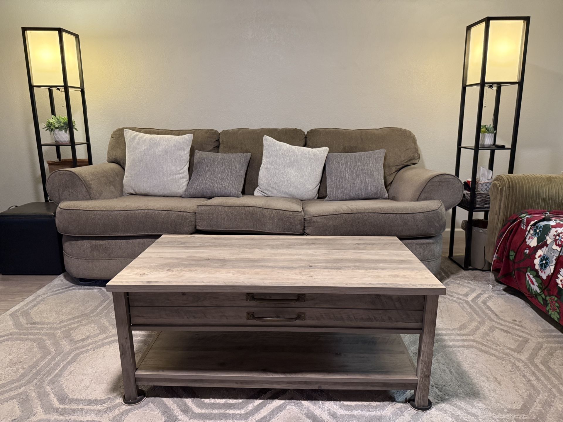 Comfortable Gray Couch, Coffee Table With Storage And Black Floor Lamps With Display Shelves