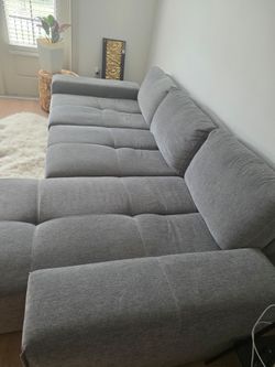 Gray Modular Sectional with adjustable backrests.