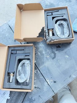 2 black faucets new in box.