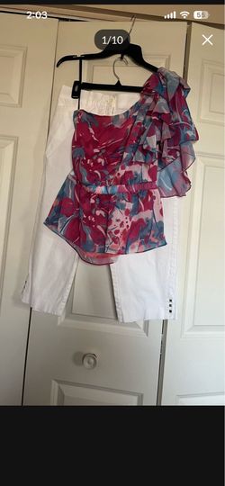 There is A two Pieces a Capri pants in size Large and blouse in size extra small both for $20 total