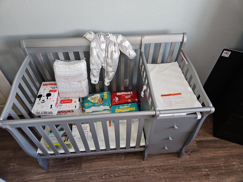"Complete Baby Bundle: Crib/Changer, 6 Diaper Packs, Winter Onesie, and Newborn Bottle Set - All Brand New!