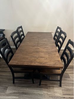 Expandable six person dining room table with chairs