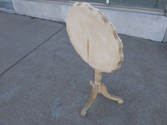 Antique off white tilt top three legged table for sale