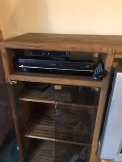 Oak cabinet with glass doors , 3 shelves With The Glass And  1 shelf underneath On Right , hole for tv Or Stereo Cabinet On Other Side 