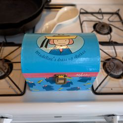 Madeline in Paris clothes trunk