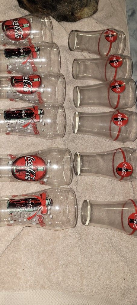 Vintage Coca-Cola Christmas glasses, specifically known for their festive "ribbon" or "snowflake and bottle" design. They were often released as promo