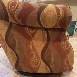 A pair of swivel barrel lounge chairs