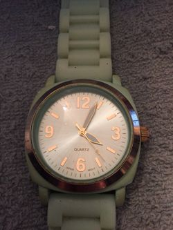 Silver tone watch with aqua face and rubber band