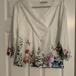 White top with floral/butterfly detailing 