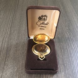 Colibri 17 jewel swiss made pocket watch. Never worn runs well keeps good time. 1 3/4” diameter in original display case