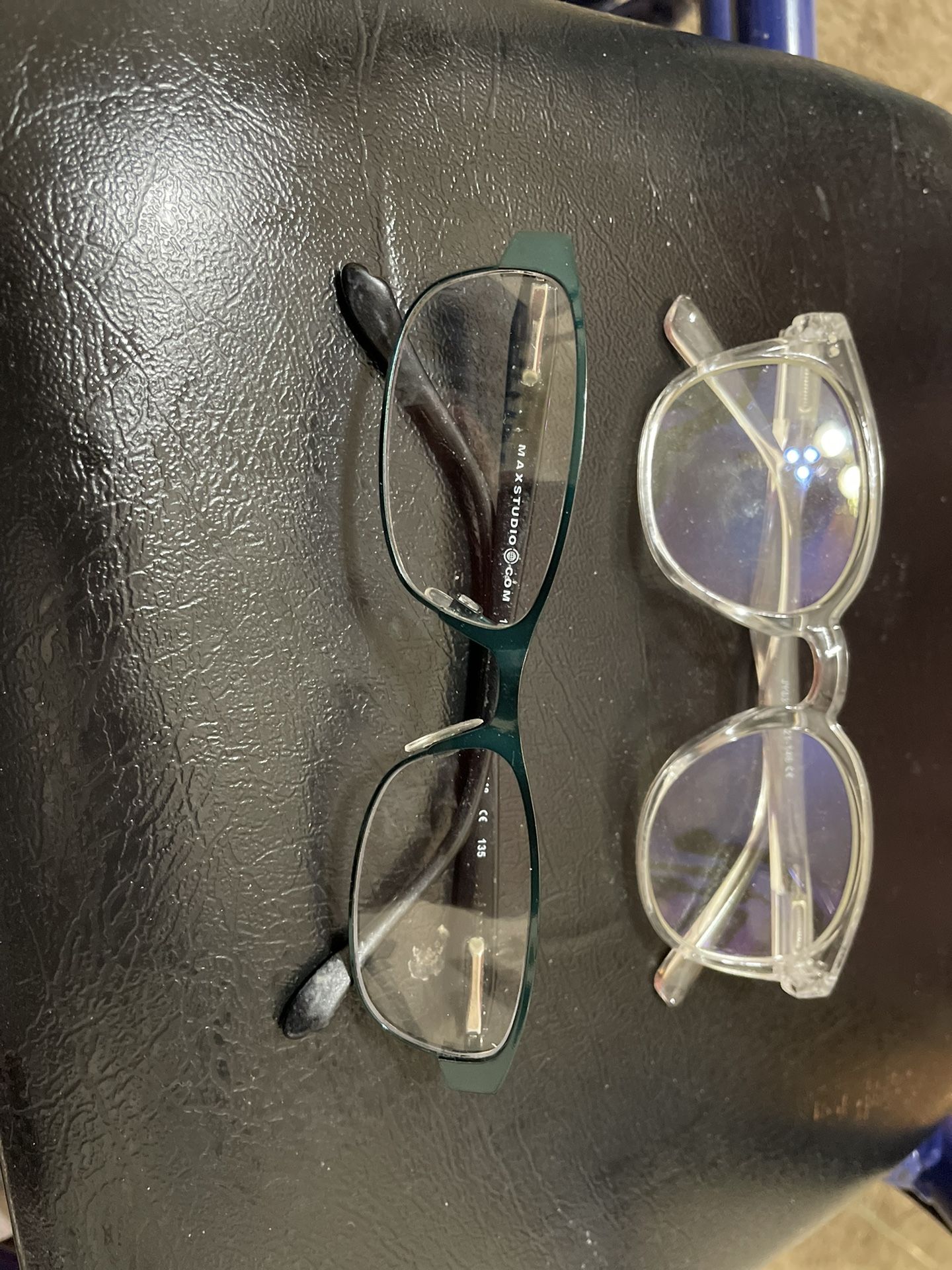 Readers one is round clear plastic frame one is rectangle metal frame dark green color $10.00 each
