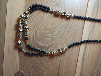 A black necklace with gold around it
